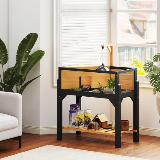 Wooden tortoise habitat cabinet with clear front window and interior plants