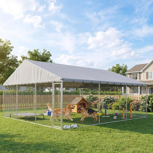 Outdoor chain-link dog run with gray roof and divided play area in backyard