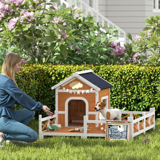 Outdoor wooden dog house with arched door and side porch, dogs standing in front