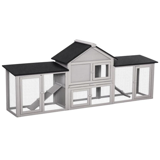 Gray wooden 2-story rabbit hutch with side enclosures and ladder