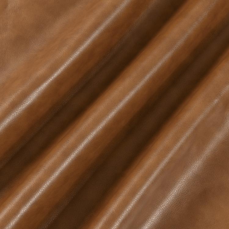 Brown PU leather upholstery close-up with stitched grain texture