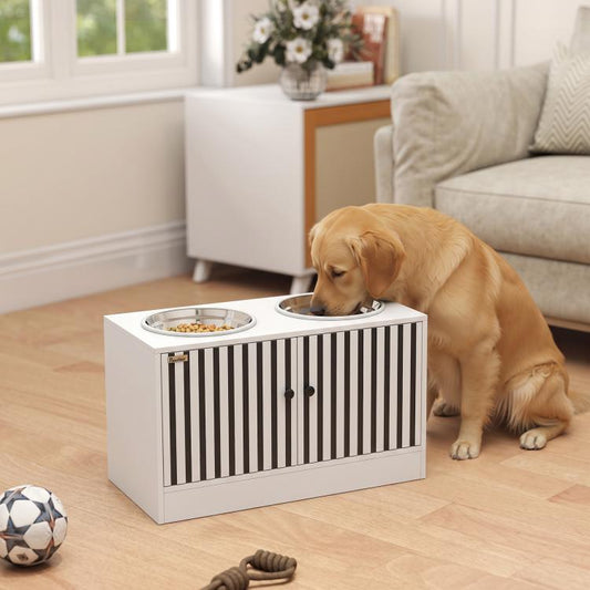 Golden retriever eating from an elevated white dog feeding station with two stainless bowls