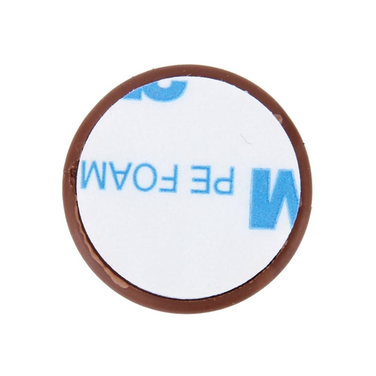 Brown cable clip, close-up round shape with cord channel opening