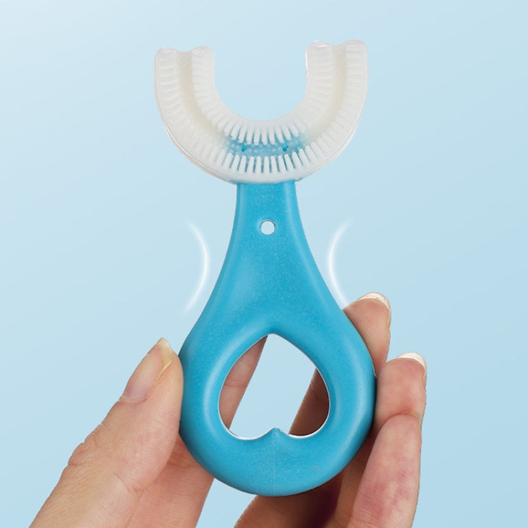 Blue U-shaped children’s toothbrush held in hand with soft bristle head
