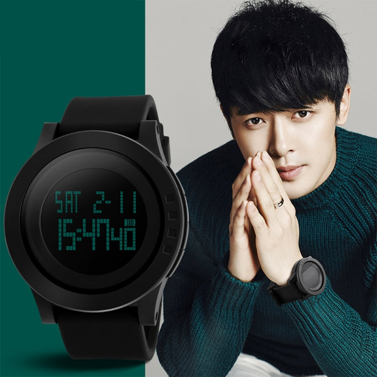 Black digital sports watch on model, round face showing pixel-style time