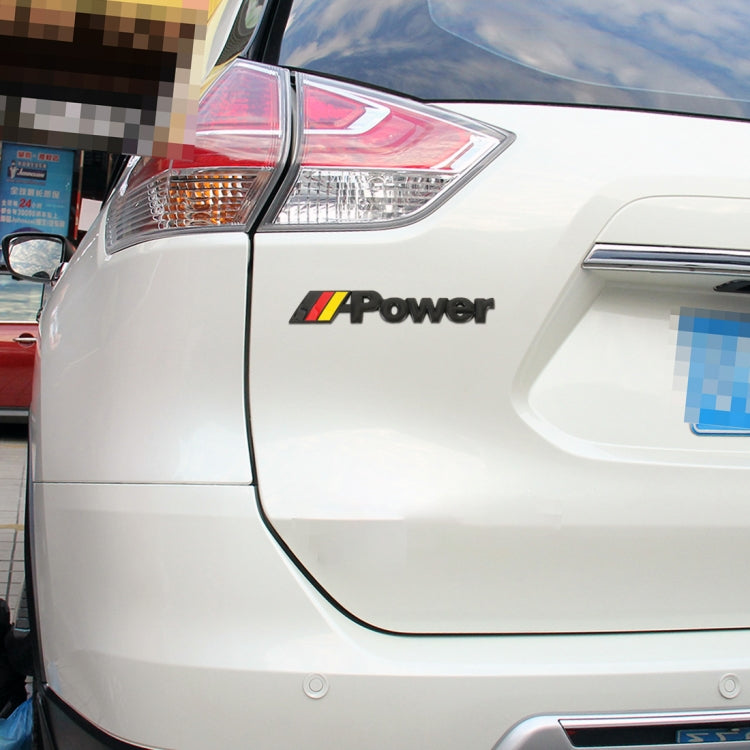 Car rear side panel with “Power” emblem sticker and small Germany flag stripe near the tail light.
