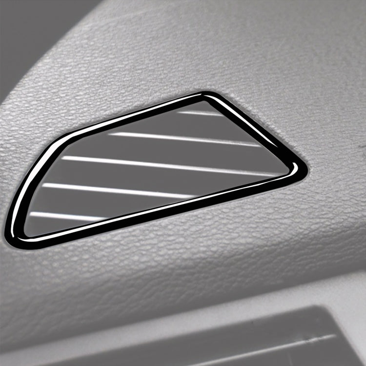 Dashboard air vent frame sticker close-up, black trim with silver slat insert