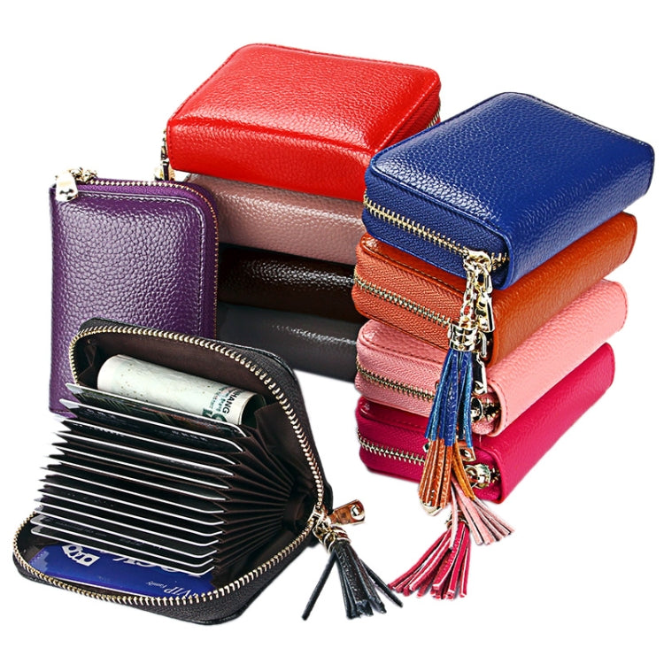Stack of cowhide leather zipper card holder wallets with tassels in assorted colors