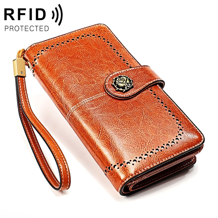 Brown RFID wallet clutch with round badge clasp and wrist strap