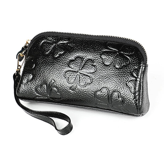 Black litchi-texture zip wristlet wallet with embossed clover pattern and gold zipper