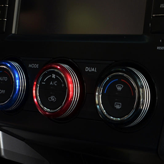 Air conditioner control knob trim rings, blue/red/silver accents around three knobs