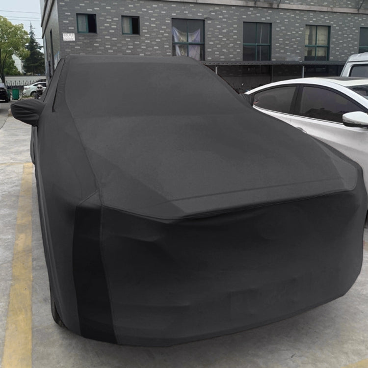 Black sedan car cover draped over front and sides, smooth protective wrap