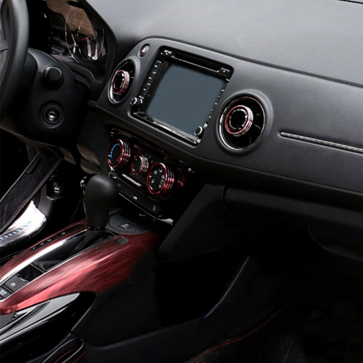 Blue aluminum air vent knob cover rings on dashboard with ridged trim