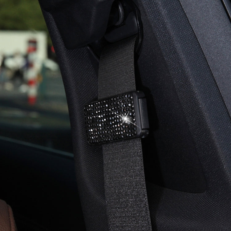Seat belt adjuster clip with black rhinestone crystal panel, close-up