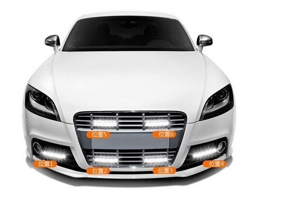 Vehicle front with LED daytime running light bars illuminated