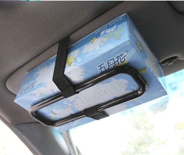 Black car hanging tissue box holder securing tissue box with fabric strap