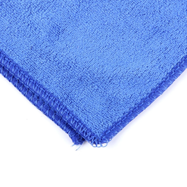 Thick velvet hand towel corner, blue looped pile with stitched hem and lightly frayed edge.