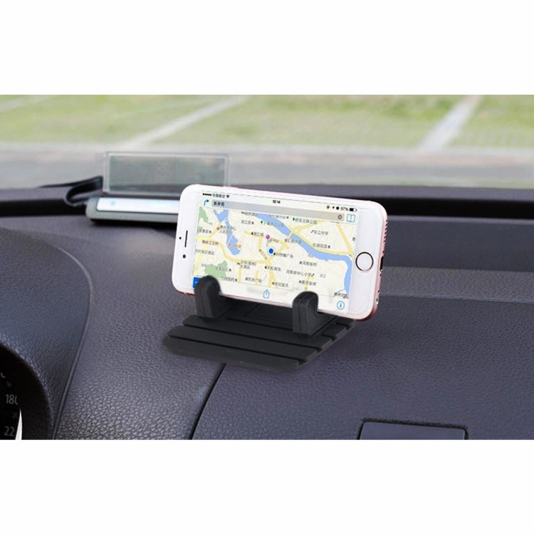 Black phone car dashboard stand holding a white smartphone with map screen