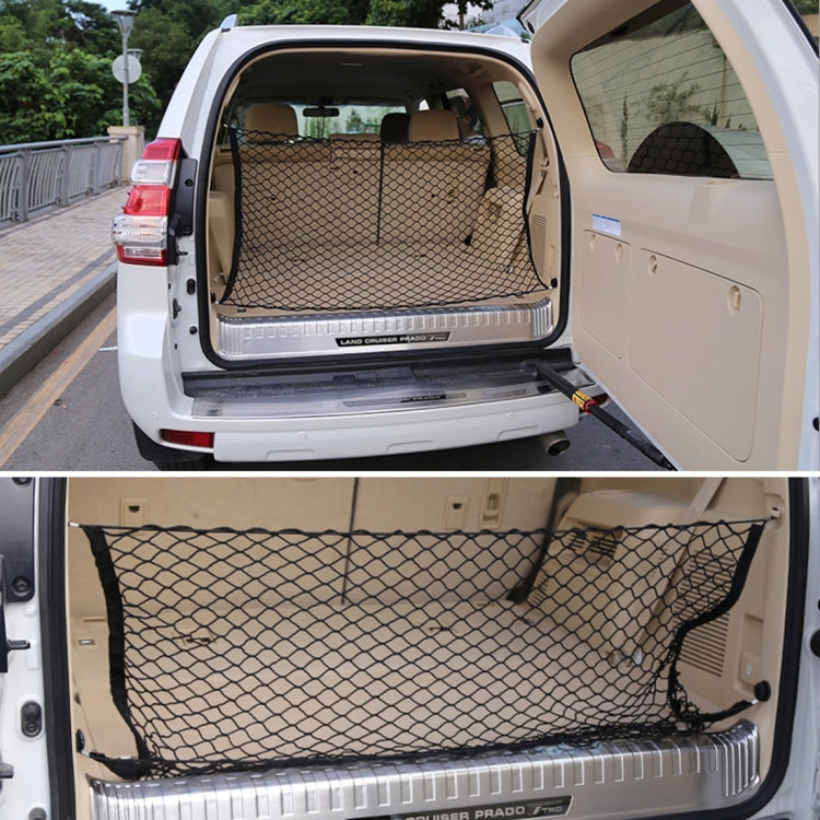 Black mesh trunk cargo net installed across the rear of a car with hook straps