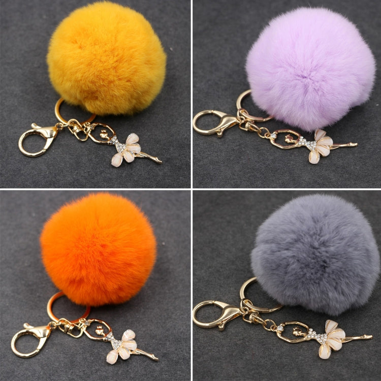 Set of fuzzy pom pom keychains: yellow, lavender, orange, and gray with butterfly charm