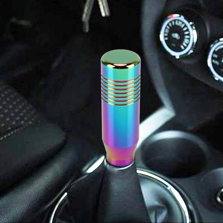 Rainbow metallic gear shift knob installed in a car interior