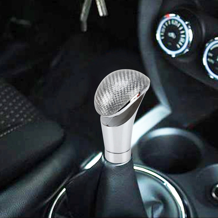 Chrome gear shift knob with carbon-fiber style top installed in car center console