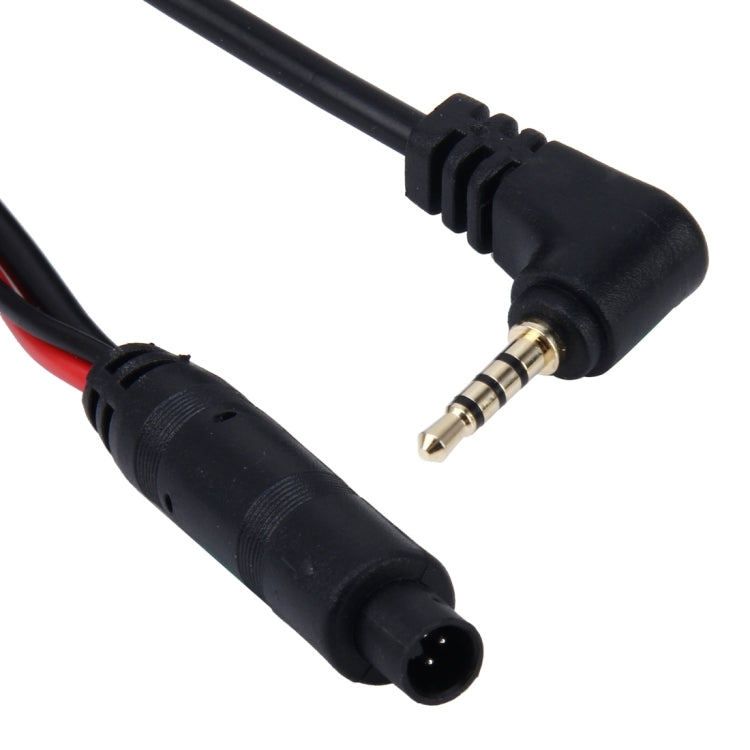 Rearview camera extension cord close-up with metal plug and black 4-pin socket connector