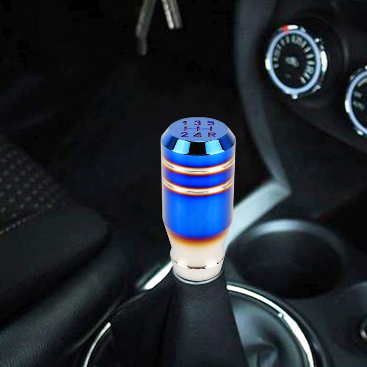 Blue 5-speed gear shift knob installed on a car manual shift boot