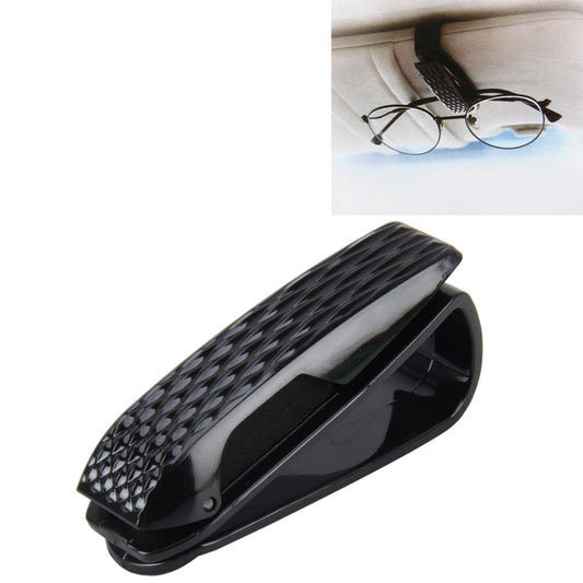 Car glasses holder clip mounted on dashboard, holding eyeglasses and frames