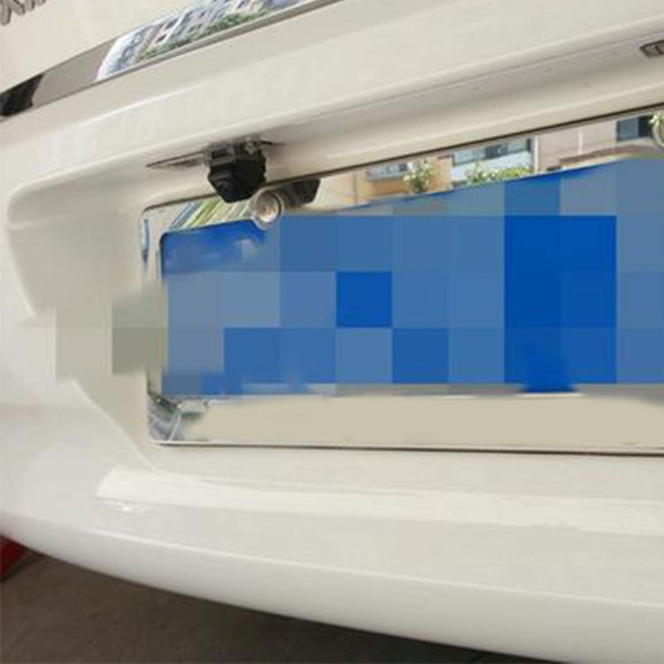 Car rear view backup camera installed near the license area with black housing
