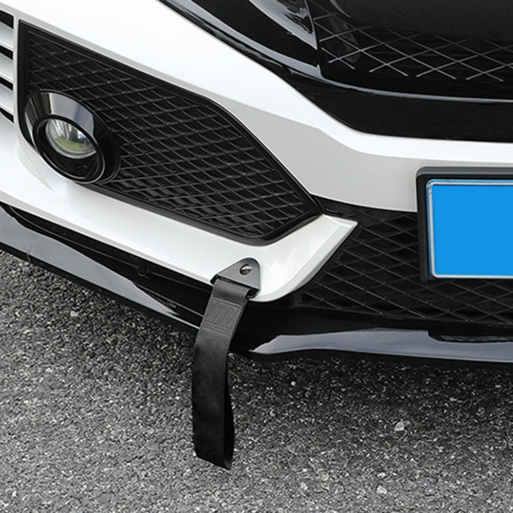 Tow strap attached to front bumper with black strap and screw-hole mounting tab