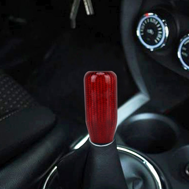 Red carbon-fiber style gear shift knob cover shown on a car shifter.