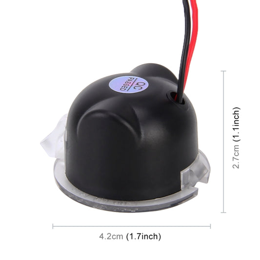 Compact black LED puddle light housing with red wire lead and size markings.