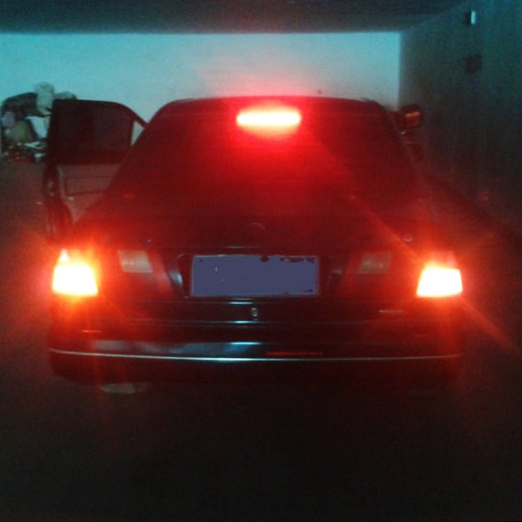Vehicle with bright red lights illuminated in a dim indoor setting