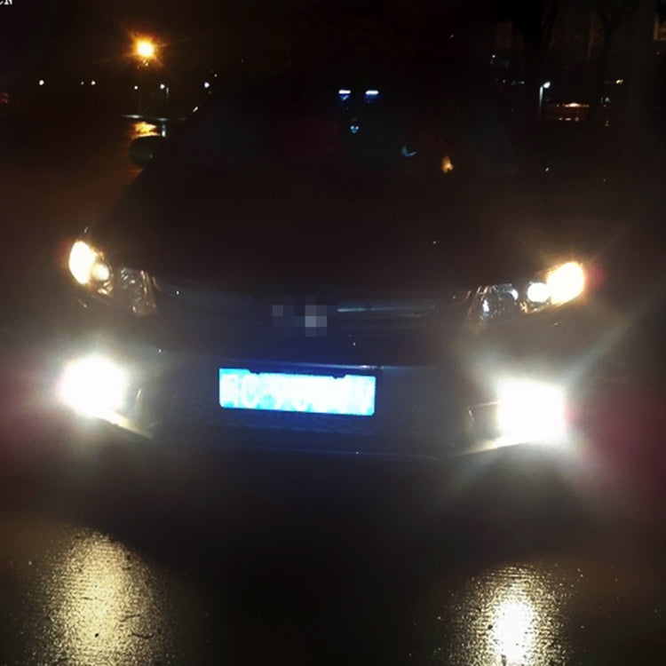 Car front at night with white fog lights on, bright illumination around the bumper