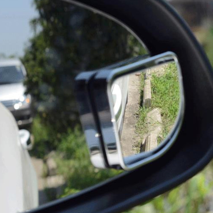 Car side blind spot mirror installed near window, chrome frame with reflective glass