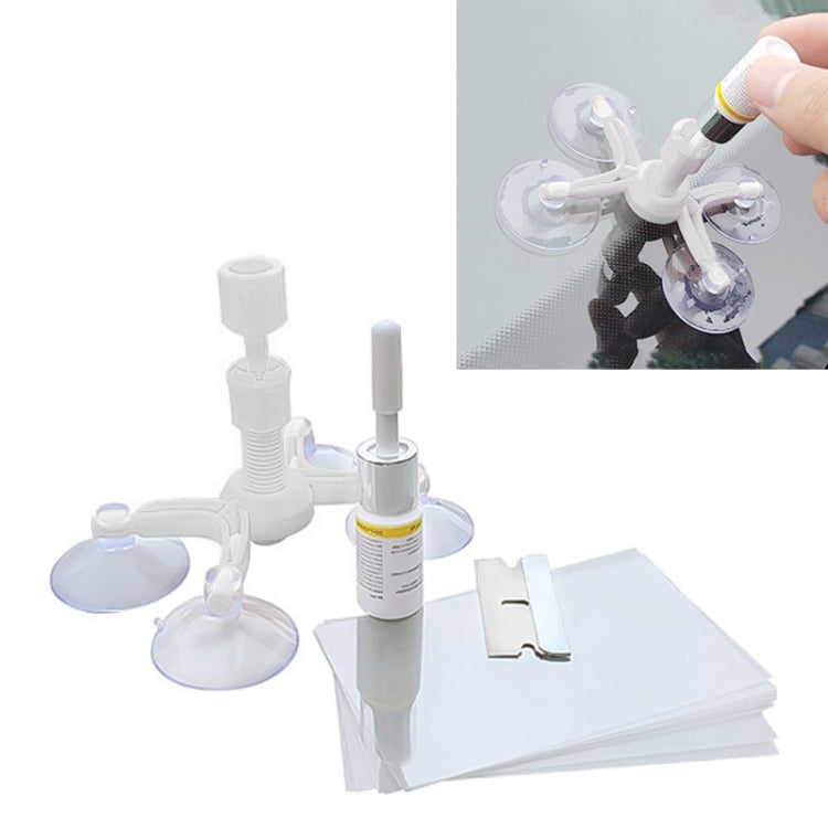 White windshield repair kit with multiple suction cups, applicator, and bottles plus pads