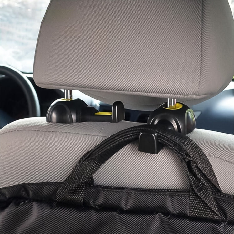 Black car seat back hooks holding bag strap and cords, close-up view