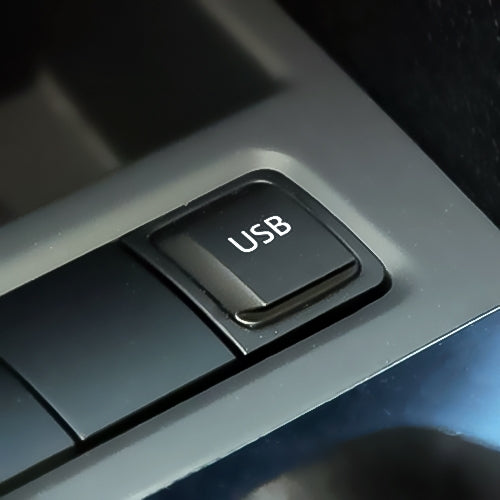 Black rectangular USB switch plug on car dashboard with "USB" label