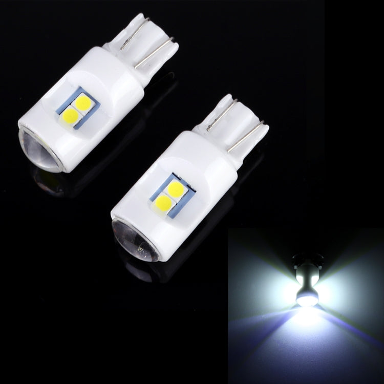 Pair of white T10/W5W projector-lens LED bulbs, bright white light glow shown