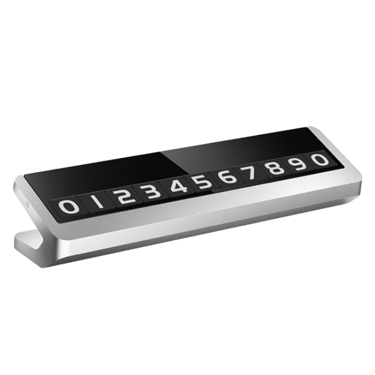 Silver-tone magnetic parking card sticker with black number panel and white digits.