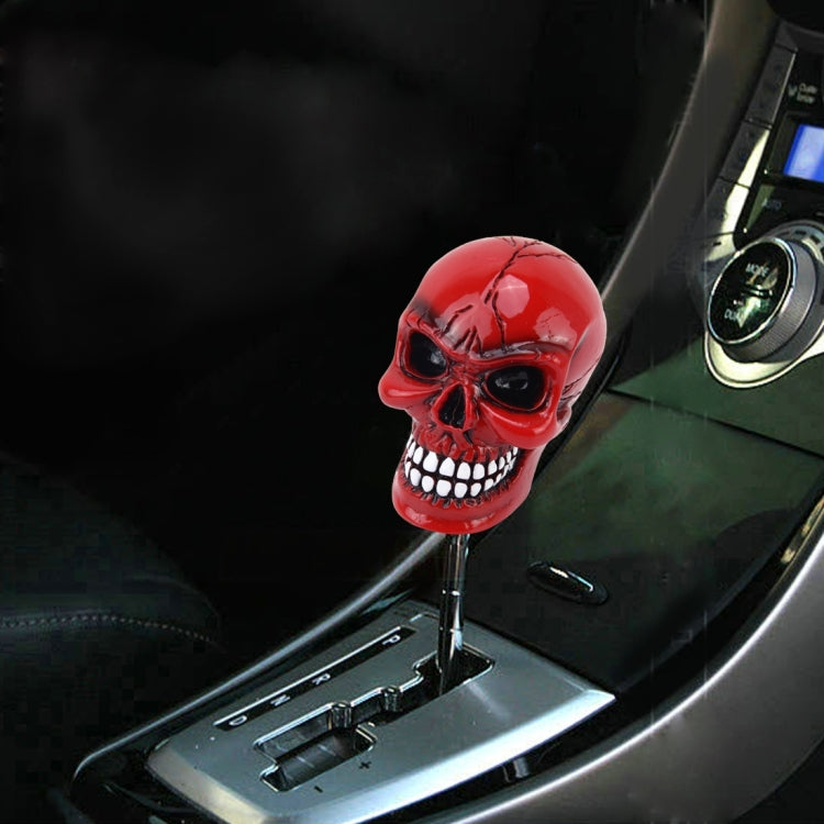 Red skull gear shift knob with black base installed on car console