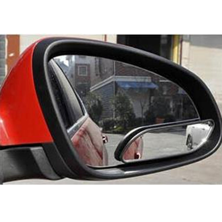 Black adjustable blind spot mirror attached to a car door, wide reflective lens.