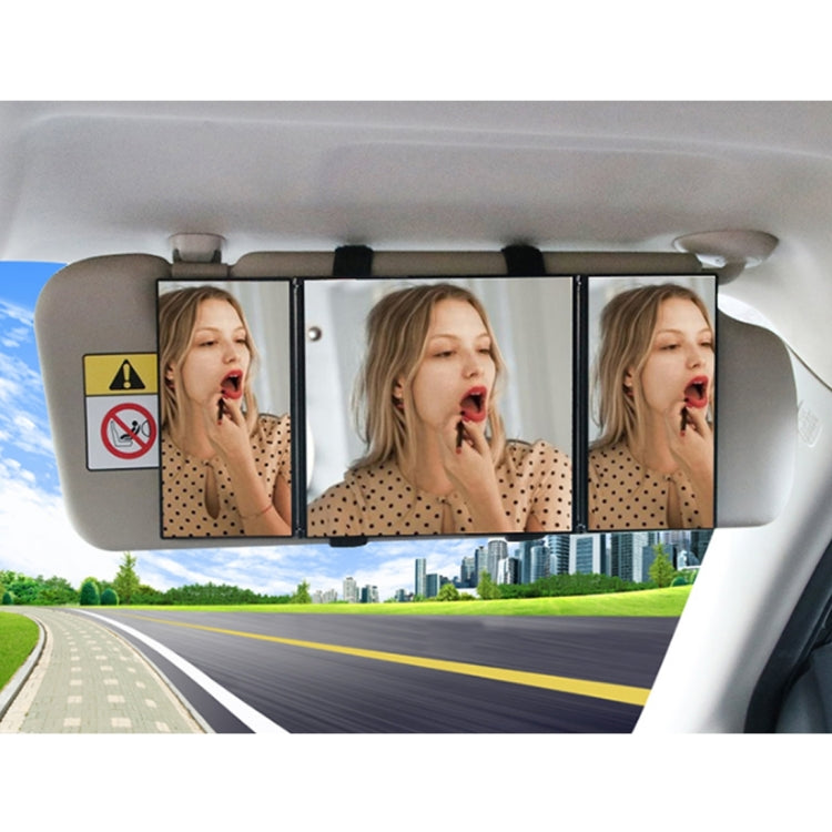 Car visor makeup mirror with three reflective panels open for makeup