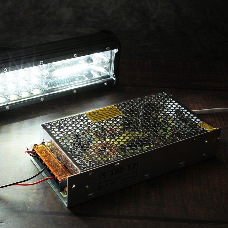 DC 12V power adapter with metal housing, angled view with terminal connections