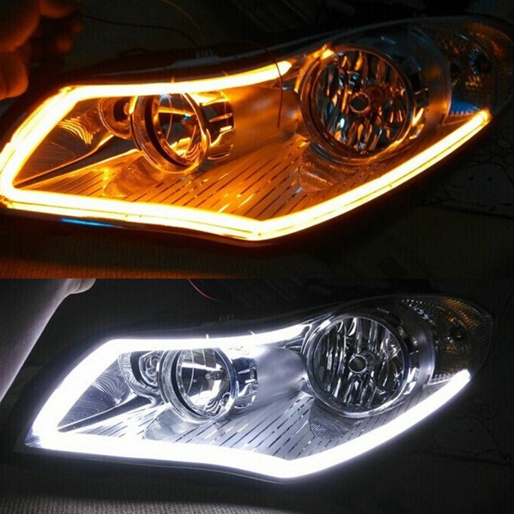 Car headlight area with double-color LED strips glowing amber and white