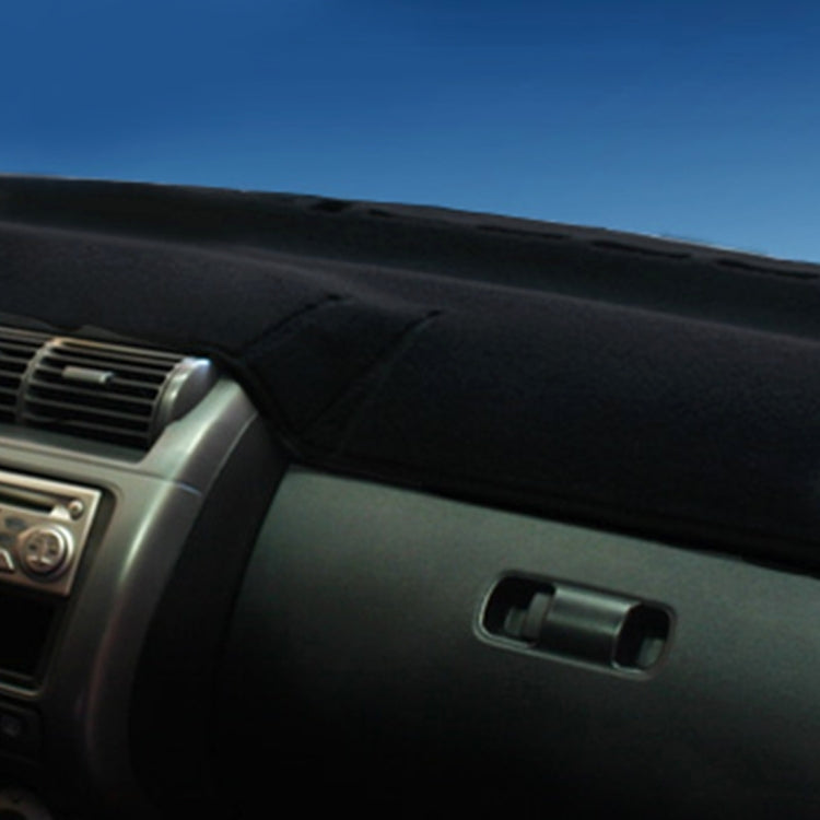 Black dashboard cover mat placed over center console area