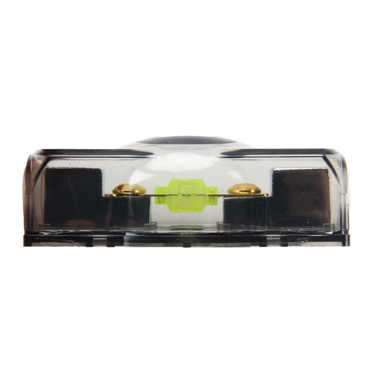 Blade fuse holder end view, clear cover showing green fuse bar and metal contacts