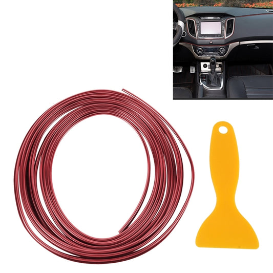 Red flexible car trim strip roll with yellow plastic scraper tool