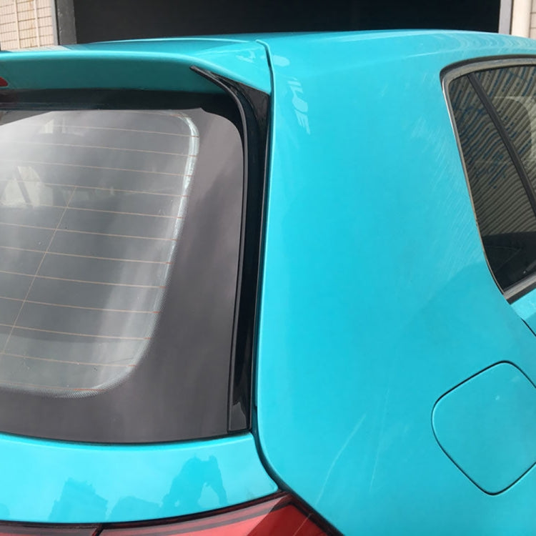 Gloss black side spoiler lip installed along rear quarter panel on a blue car